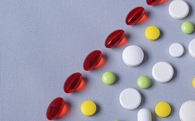 Pharmaceutical concept. Background from pills. Vitamins in capsules and multi-colored pills of...