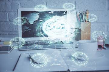 Computer on desktop with social network hologram. Multi exposure. Concept of international people connections.