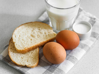 Breakfast ingredients. Still life of eggs, milk and bread on a white background. Close-up