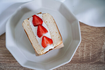 Souffle pancake sandwich. A fluffy pancake filling with fresh cream and strawberry, top view. (closeup)