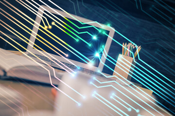 Double exposure of desktop computer and technology theme hologram. Concept of software development.