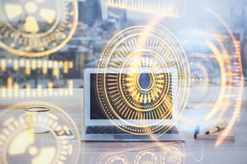 Fototapeta premium Computer on desktop in office with technology theme hologram. Multi exposure. Tech concept.