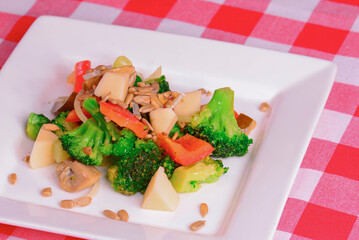 Vegetable salad with broccoli cabbage, cheese, lettuce, mushrooms, cucumber, sunflower seeds and fresh parsley.