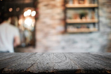 Empty wooden table space platform and blurred restaurant or coffee shop background for product display montage.