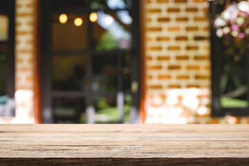 Empty wooden table space platform and blurred restaurant or coffee shop background for product display montage.