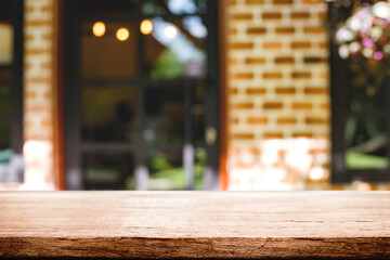 Empty wooden table space platform and blurred restaurant or coffee shop background for product display montage.