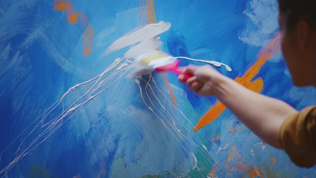 Female artist making emotional art on canvas in workshop. Modern artwork paint on canvas, creative, contemporary and successful fine art artist drawing masterpiece