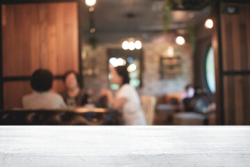 Empty wooden desk space platform and blurred restaurant or coffee shop background for product display montage.