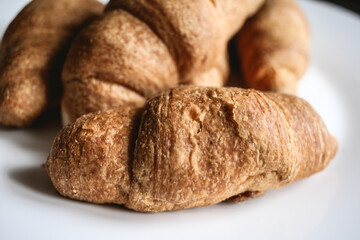 Croissants on a white plate. Fresh bakery
