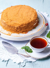 Homemade honey cake with sour cream. Black tea and mint
