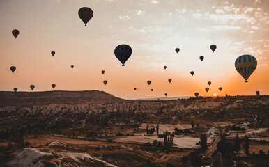 Sunrise in Cappadocia Turkey. Hot air balloons in Goreme valley. Flight above mountains. travel destination. Colorful balloon.