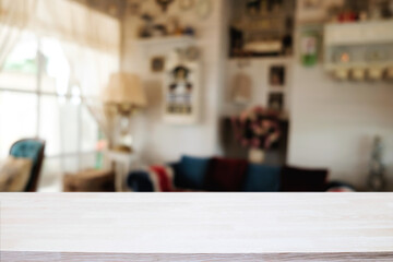 Wooden desk space platform and blurred restaurant or coffee shop background for product display montage.