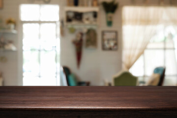 Empty wooden table space platform and blurred restaurant or coffee shop background for product display montage.