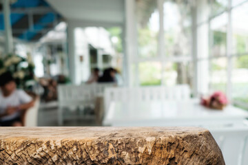 Empty wooden table space platform and blurred restaurant or coffee shop background for product display montage.
