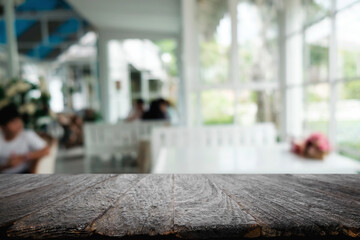 Empty wooden table space platform and blurred restaurant or coffee shop background for product display montage.