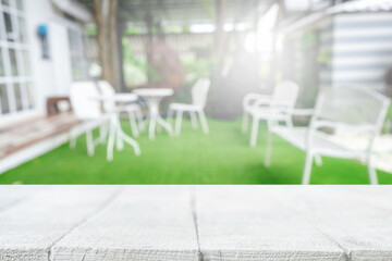 Empty wooden table space platform and blurred restaurant or coffee shop background for product display montage.