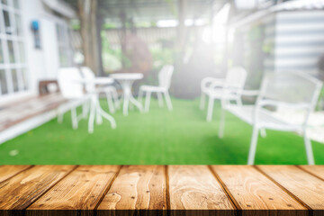 Empty wooden table space platform and blurred restaurant or coffee shop background for product display montage.