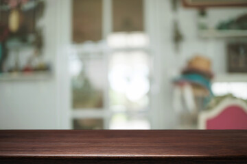 Empty wooden table space platform and blurred restaurant or coffee shop background for product display montage.