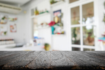 Empty wooden table space platform and blurred restaurant or coffee shop background for product display montage.