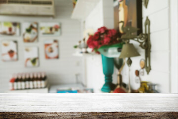 Empty wooden table space platform and blurred restaurant or coffee shop background for product display montage.