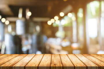 Empty wooden table space platform and blurred restaurant or coffee shop background for product display montage.