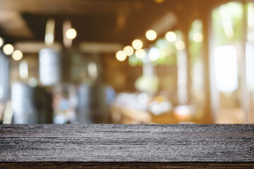 Empty wooden table space platform and blurred restaurant or coffee shop background for product display montage.