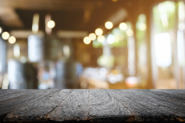 Empty wooden table space platform and blurred restaurant or coffee shop background for product display montage.