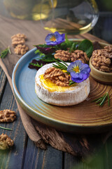 Baked Brie Cheese with Honey, Nuts and White Wine. Beautiful still life for poster or wallpaper for the kitchen