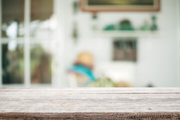 Empty wooden desk space platform over blurred restaurant or coffee shop background for product display montage.