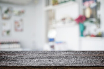 Empty wooden desk space platform over blurred restaurant or coffee shop background for product display montage.