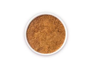 Heap of coconut sugar isolated on white background. Top view. Heap of coconut sugar on white. Dark sugar isolated on white. Organic coconut unrefined sugar, isolated. Selective focus.