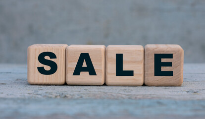 SALE word on cubes on an old gray background .