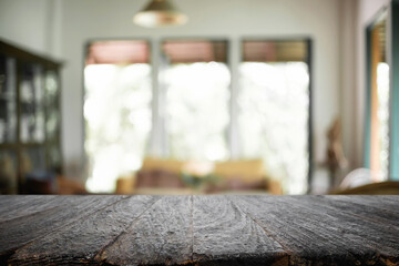 Empty wooden desk space platform over blurred restaurant or coffee shop background for product display montage.