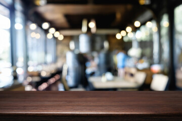 Obraz na płótnie Canvas Desk space platform over blurred restaurant or coffee shop background for product display montage.