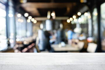 Fototapeta premium Desk space platform over blurred restaurant or coffee shop background for product display montage.