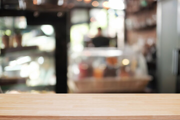 Empty wooden desk space platform over blurred restaurant or coffee shop background for product display montage.