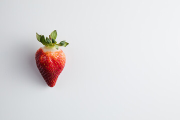 Close-up of a strawberry on a white table. Fresh berries