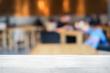 Empty wooden table space platform and blurred restaurant or coffee shop background for product display montage.