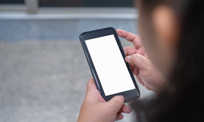 The top view of a woman holding a phone with a blank white screen. She played games, sent messages, played social media.Mockup
