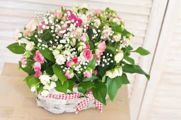 Flowers bouquet in wicker basket