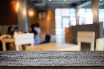 Empty wooden table space platform and blurred restaurant or coffee shop background for product display montage.