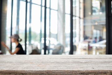 Empty wooden table space platform and blurred restaurant or coffee shop background for product display montage.