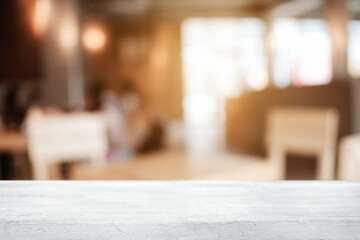 Empty wooden table space platform and blurred resturant or coffee shop background for product display montage.