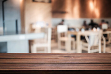 Empty wooden table space platform and blurred restaurant or coffee shop background for product display montage.