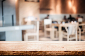 Empty wooden table space platform and blurred restaurant or coffee shop background for product display montage.