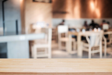 Empty wooden table space platform and blurred restaurant or coffee shop background for product display montage.