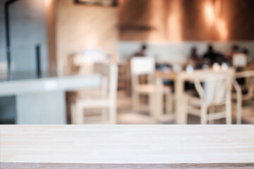 Empty wooden table space platform and blurred restaurant or coffee shop background for product display montage.