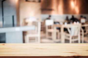 Empty wooden table space platform and blurred restaurant or coffee shop background for product display montage.