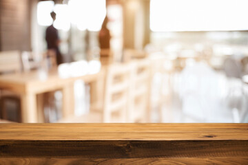 Empty wooden table space platform and blurred restaurant or coffee shop background for product display montage.