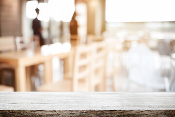Empty wooden table space platform and blurred restaurant or coffee shop background for product display montage.